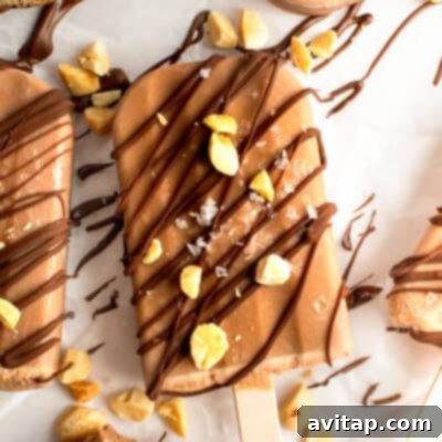 A tempting chocolate-coated ice cream bar, generously sprinkled with nuts and elegantly drizzled with extra chocolate, resting on a sheet of parchment paper.