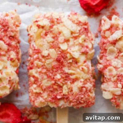 Refreshing strawberry and almond popsicles, bursting with fruity flavor, arranged neatly for a cool treat.