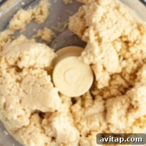 Fit Frosted Pastries 10 Close-up of dough being mixed in a food processor, forming a cohesive ball.