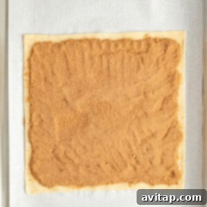 Fit Frosted Pastries 11 Rectangular dough on parchment paper with a layer of brown sugar filling spread evenly on top, ready for the next layer of pastry.