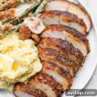 Turkey tenderloin sliced on a plate, showcasing its lean and tender texture.