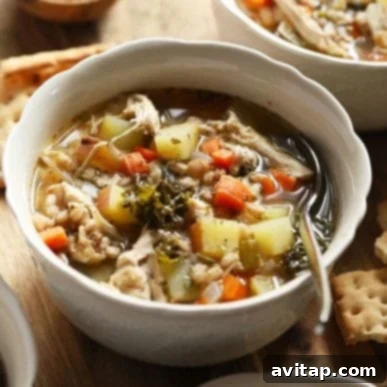 A bowl of rustic Tuscan Turkey Soup, brimming with hearty ingredients.