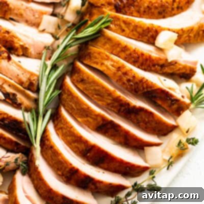 Smoked turkey breast sliced on a plate, showing its juicy interior.