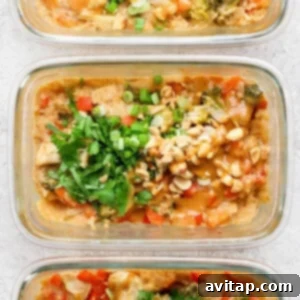 Three glass meal prep containers showcase a delicious peanut chicken stir-fry, garnished with chopped peanuts and cilantro.