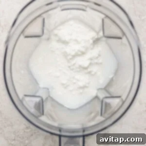 Creamy Cottage Cheese Crepes 7 Blender jug with foamy white liquid inside, viewed from above.