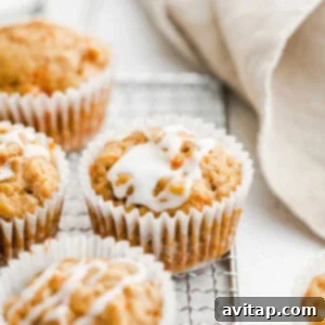 Carrot muffins cooling on a wire rack, perfectly golden brown.