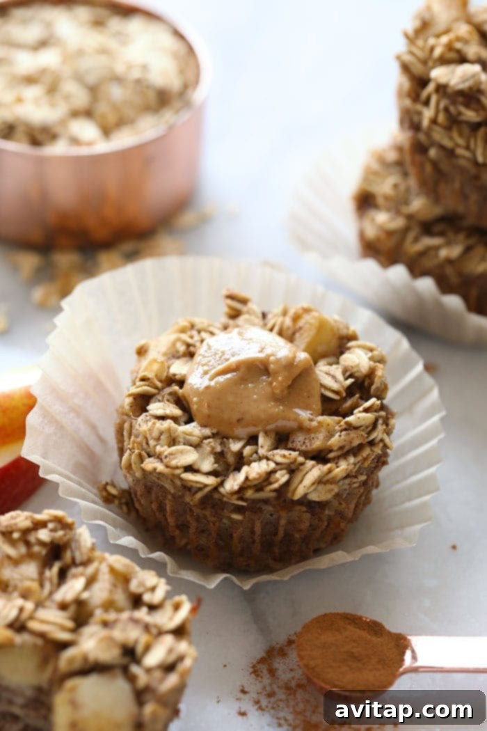 Delicious baked apple oatmeal cups drizzled with peanut butter, ready for meal prep.