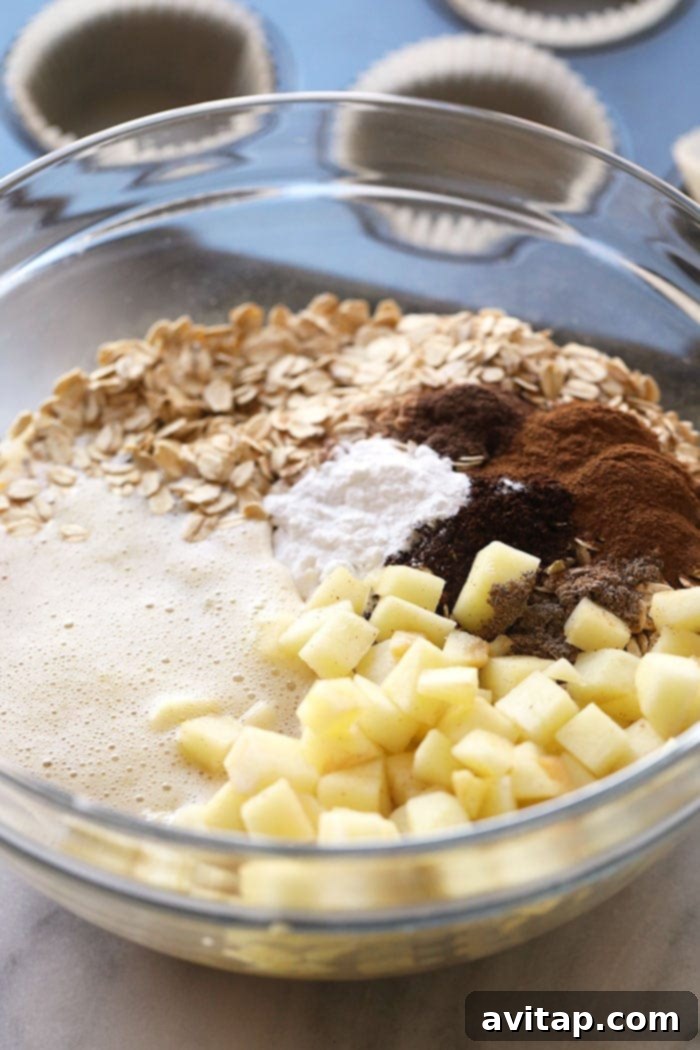 Key ingredients for making homemade baked apple chai oatmeal cups laid out on a table.