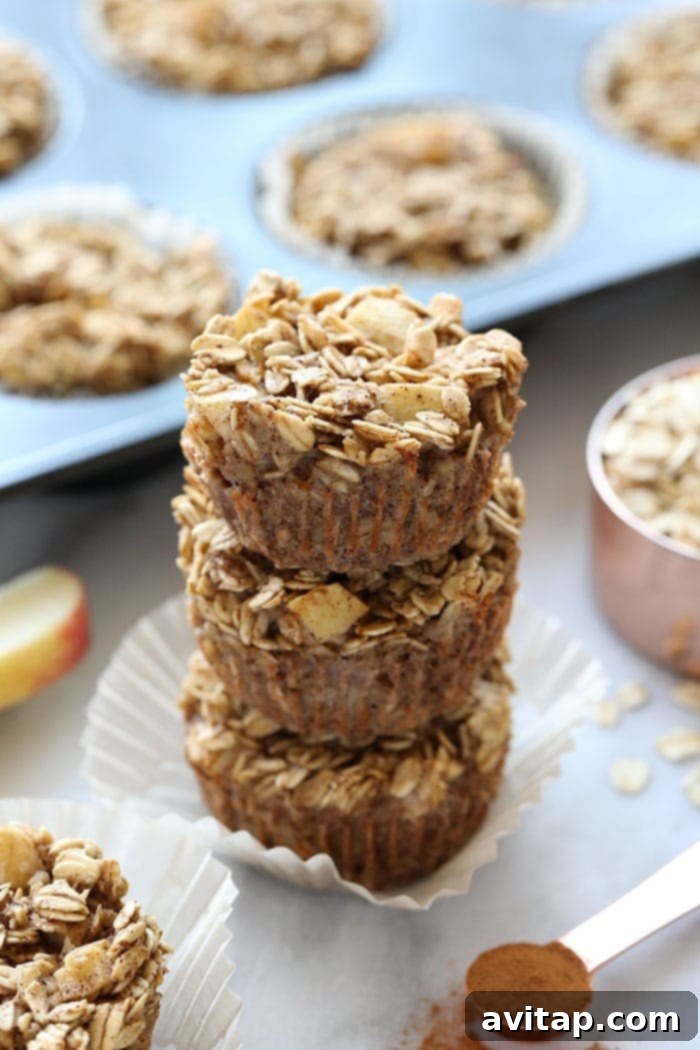 A stack of three chai spiced baked apple oatmeal cups, ready to eat or store.