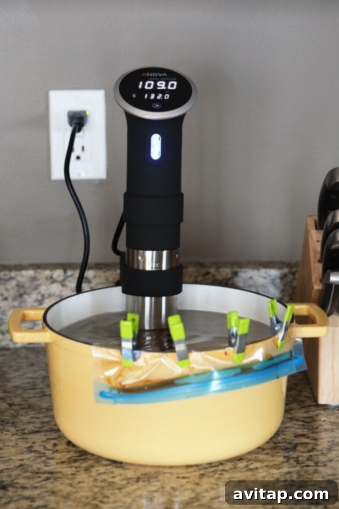 A vacuum-sealed bag containing flank steak and Mongolian sauce, submerged in a water bath with a sous vide immersion circulator attached to the pot, showing the precision cooking process.