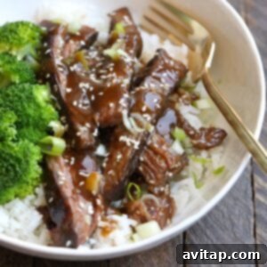 Sous vide flank steak and broccoli in a white bowl, ready to be eaten.