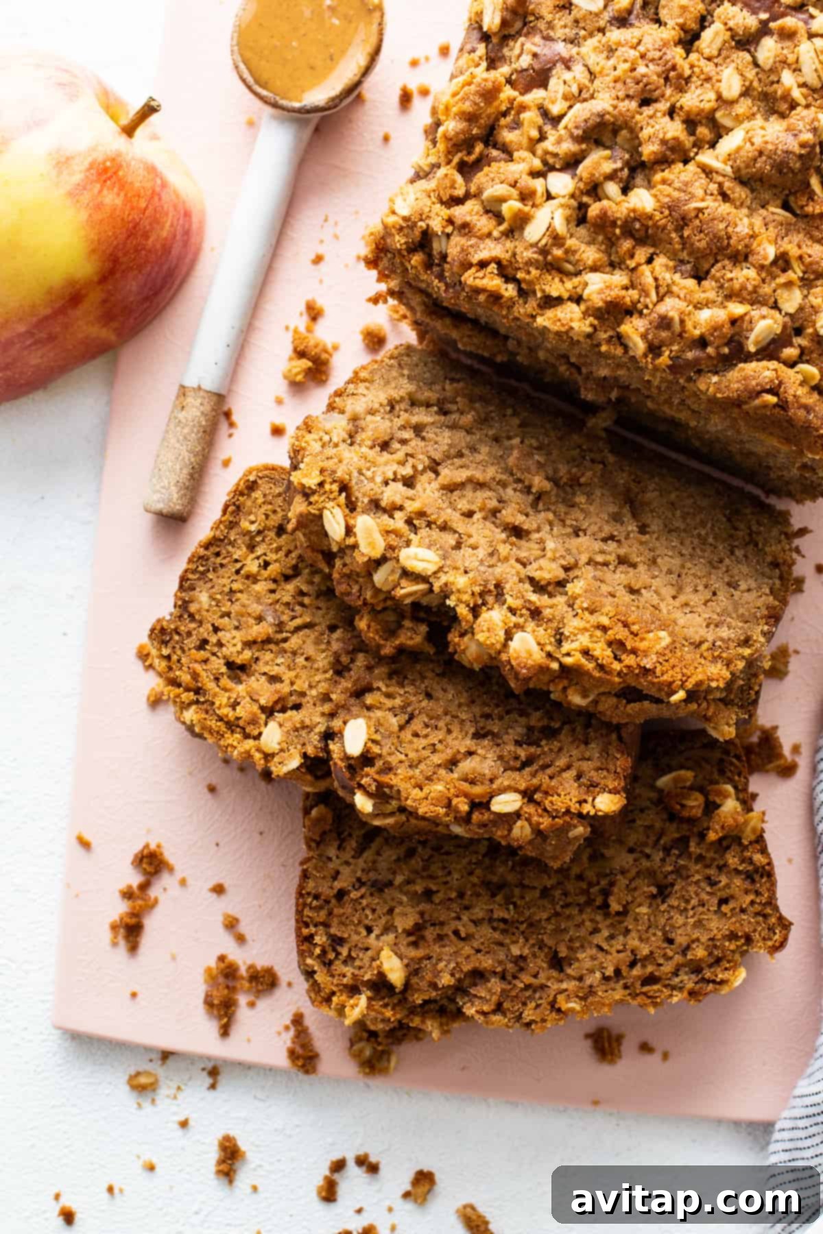 A beautifully baked loaf of Peanut Butter Apple Streusel Bread, perfectly golden brown and showing its rich streusel topping.