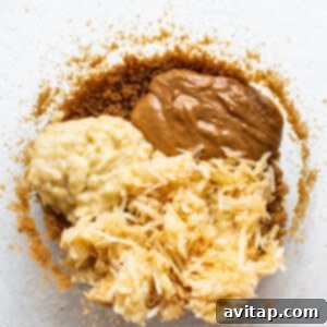 Wet ingredients for peanut butter apple bread being mixed in a large bowl.