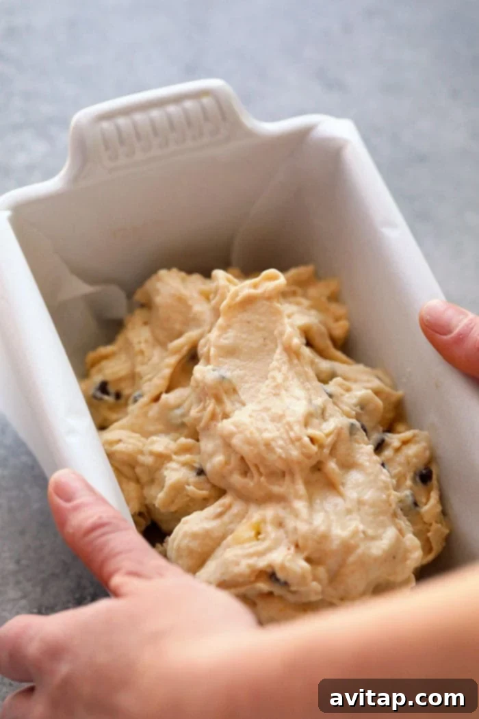 Freshly blended peanut butter banana nice cream poured into a loaf pan, ready for freezing.