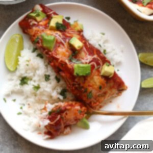 Healthy enchilada served over rice topped with avocado