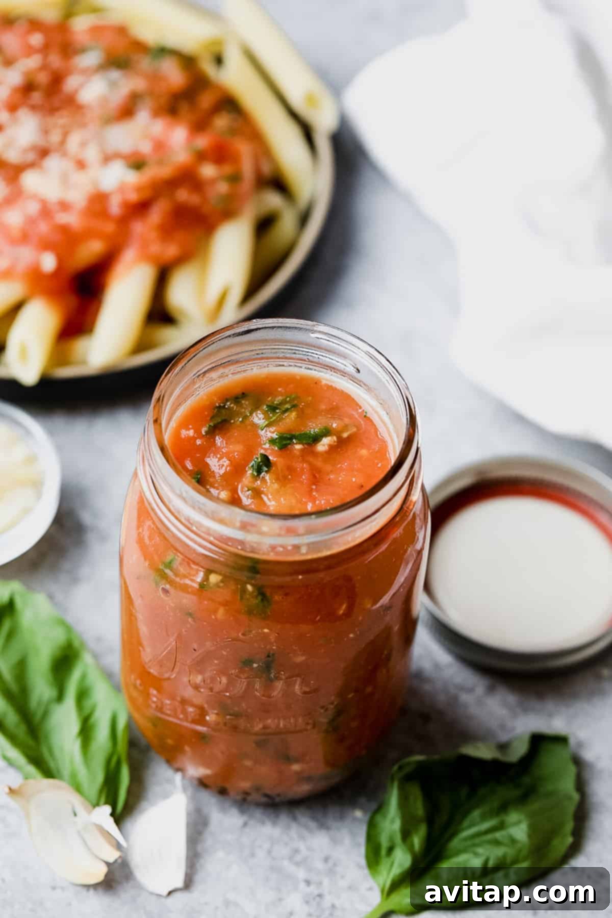 Make your own homemade roasted tomato sauce using fresh, juicy tomatoes from the garden! Roast your tomatoes and puree them with garlic cloves, olive oil, and fresh basil. A jar of rich roasted tomato sauce, perfectly preserved for later.