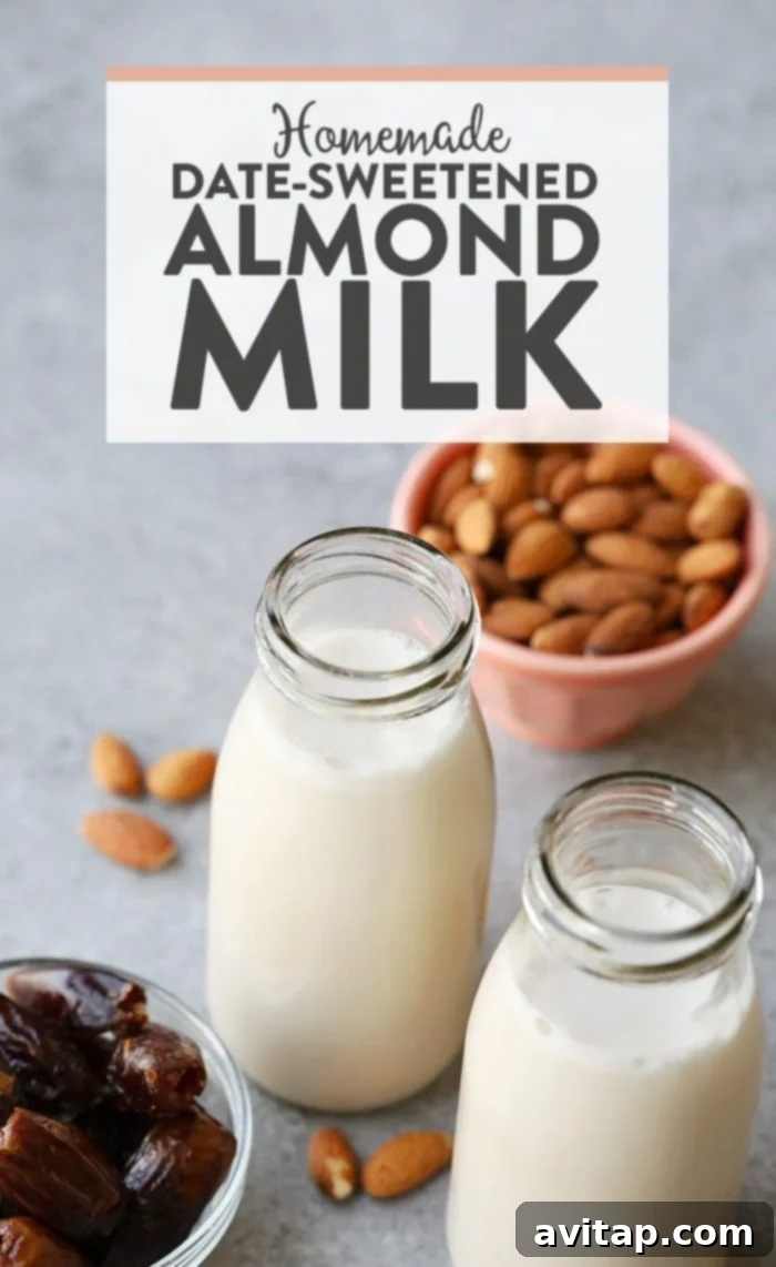 Freshly made homemade almond milk in a clear glass jug, ready to be served or stored.