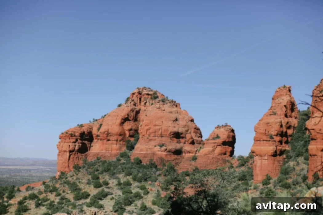 A hiker pauses to admire the vast red rock wilderness during the Bear Mountain trek in Sedona.