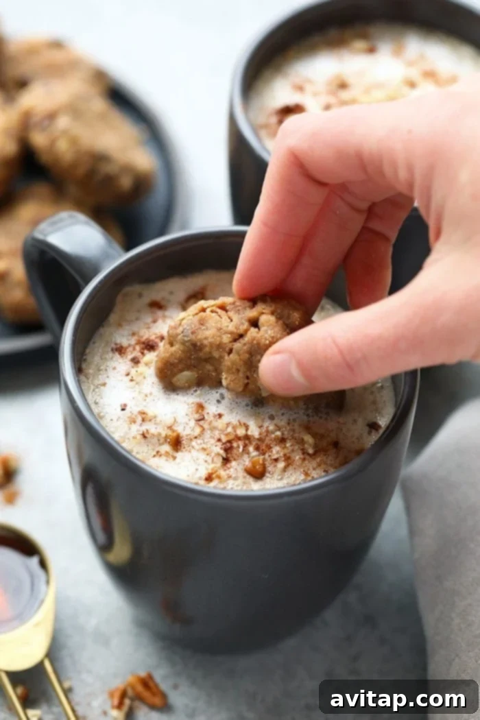 An aerial view of two maple pecan lattes with a plate of vegan cowboy cookies, perfect for a cozy morning or afternoon treat.
