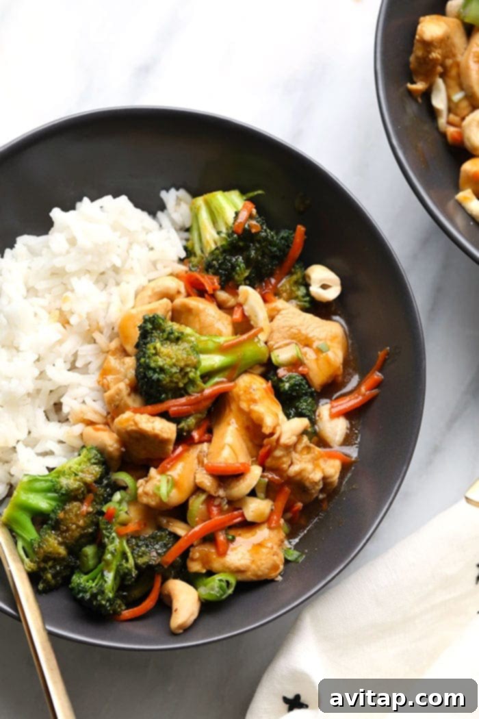 A vibrant bowl of homemade chicken stir fry with crisp vegetables and tender chicken, served over fluffy white rice, representing a healthier alternative to traditional takeout.