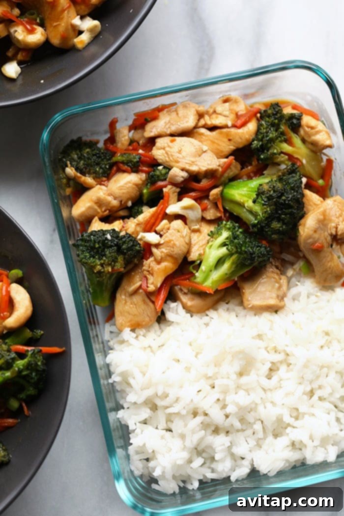A perfectly portioned serving of homemade chicken stir fry with rice, packed into a clear meal prep container, ready for a healthy lunch or dinner.
