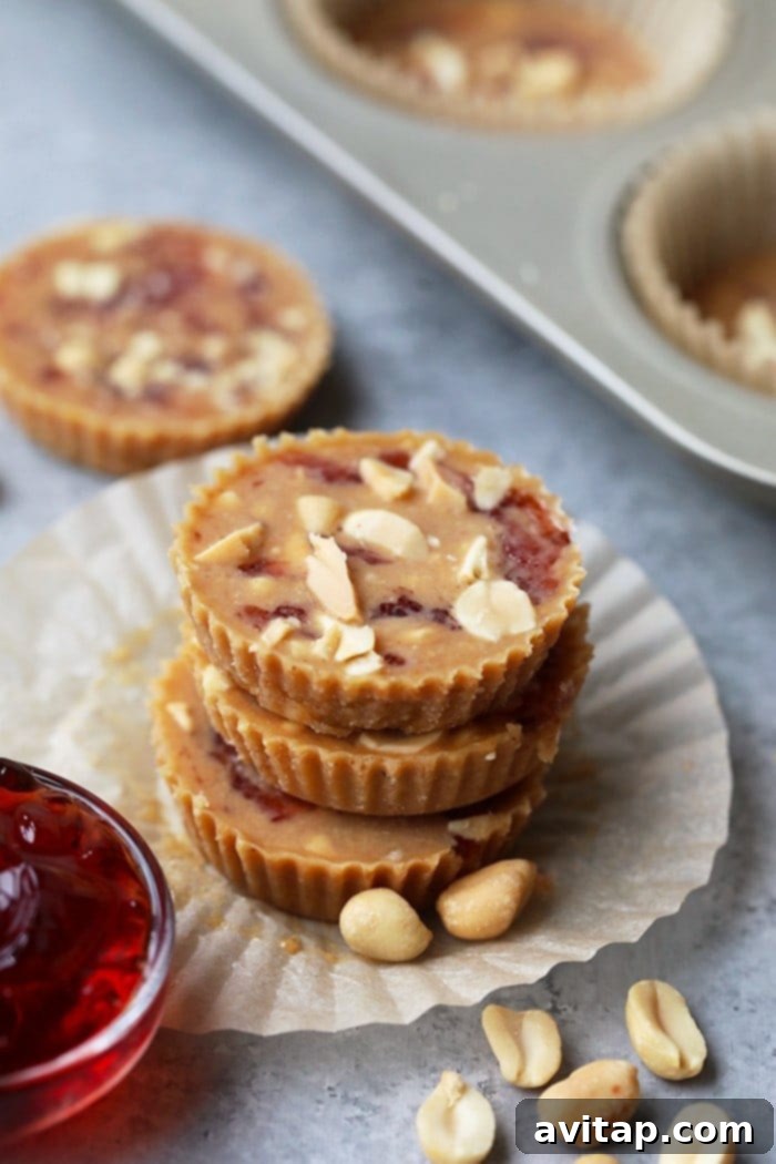 Stack of delicious crunchy peanut butter and jelly fat bombs, showing the distinct layered texture and inviting appearance, perfect for a healthy, keto-friendly snack or dessert.