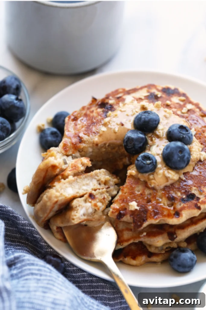 Cottage Cheese Protein Pancakes for the win! Who's with me? If you're all about healthy pancakes and getting a protein boost at the same time then you will love this protein pancake recipe! They're made with 100% ground oat flour, cottage cheese, and mashed banana. Delicious stack of cottage cheese protein pancakes drizzled with maple syrup and topped with fresh berries, offering a nutritious and satisfying breakfast.