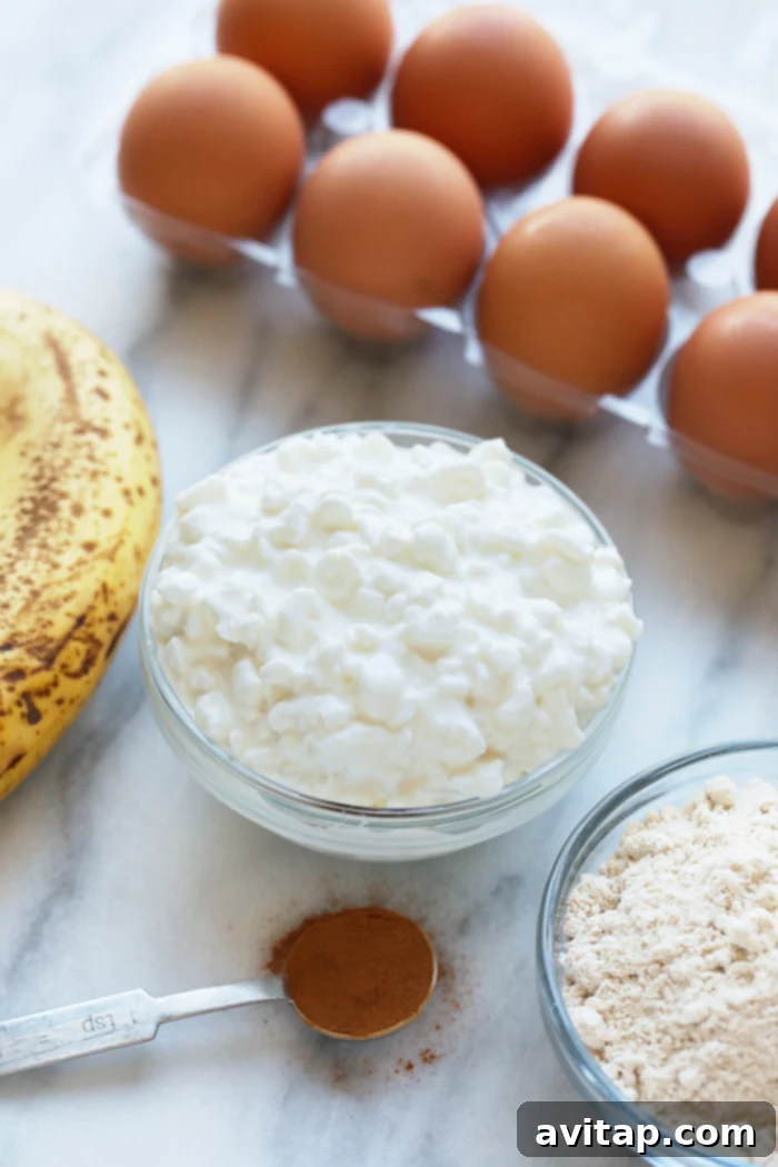 Cottage Cheese Protein Pancake for the win! Who's with me? If you're all about healthy pancakes and getting a protein boost at the same time then you will love this protein pancake recipe! It's made with 100% ground oat flour, cottage cheese, and mashed banana. A bowl of creamy cottage cheese, ready to be incorporated into the pancake batter, showcasing its fresh and inviting texture.