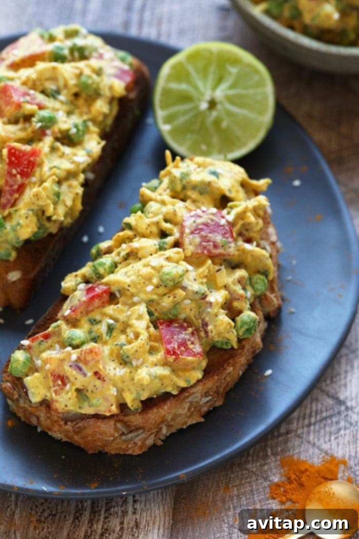Golden Curry Chicken Salad 2 Curry chicken salad on a piece of toast, showcasing its vibrant colors and creamy texture