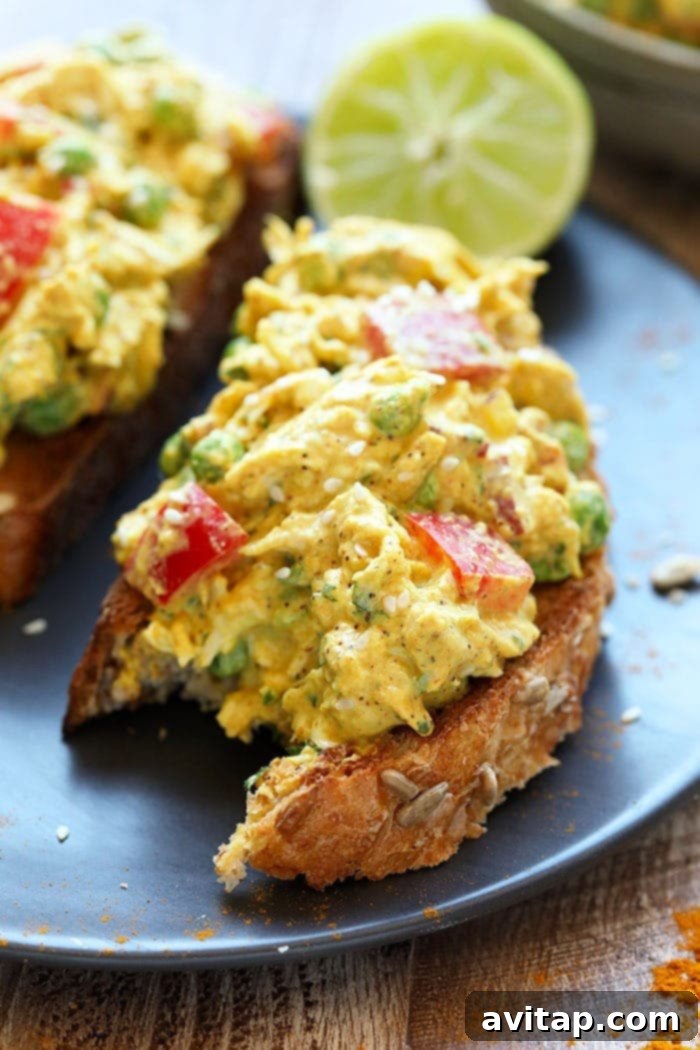 Golden Curry Chicken Salad 5 A delicious curry chicken salad sandwich with a bite taken out, showing the rich filling and fresh ingredients