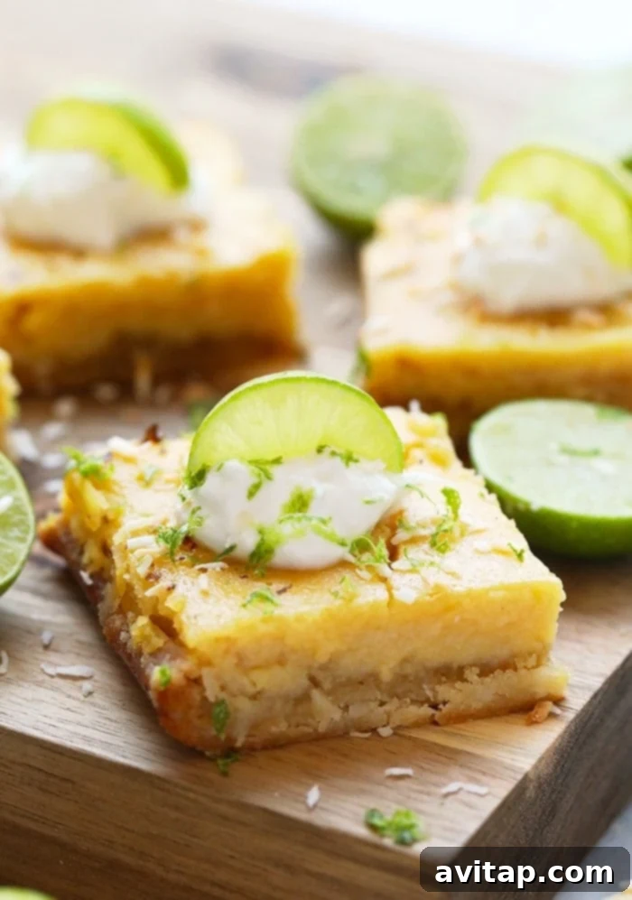 Finished Healthy Coconut Key Lime Pie Bars: A Perfect Summer Treat Beautifully sliced and chilled key lime pie bars, garnished with lime zest, ready to be served.