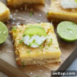 A cutting board with lime wedges and sour cream on it, perfect for making key lime pie.