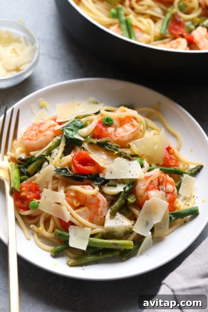 A large pot of cooked pasta and shrimp scampi ready to be served.