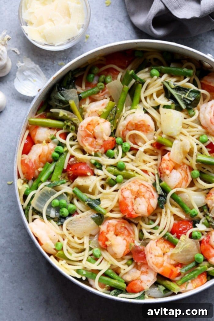 A close-up shot of a forkful of shrimp scampi pasta, ready to eat.