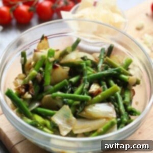 A bowl of sautéed vegetables on a cutting board, ready for the scampi.