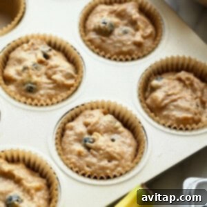 Wholesome Blueberry Muffins 6 muffin batter in muffin tin.