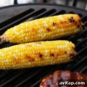 Grilled corn on the cob with a bbq glaze, showing a delicious char.