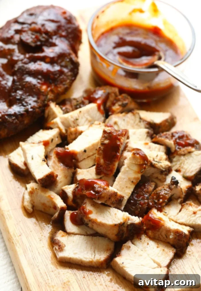 Grilled corn and BBQ chicken cooking on a hot grill, showing the delicious char marks.
