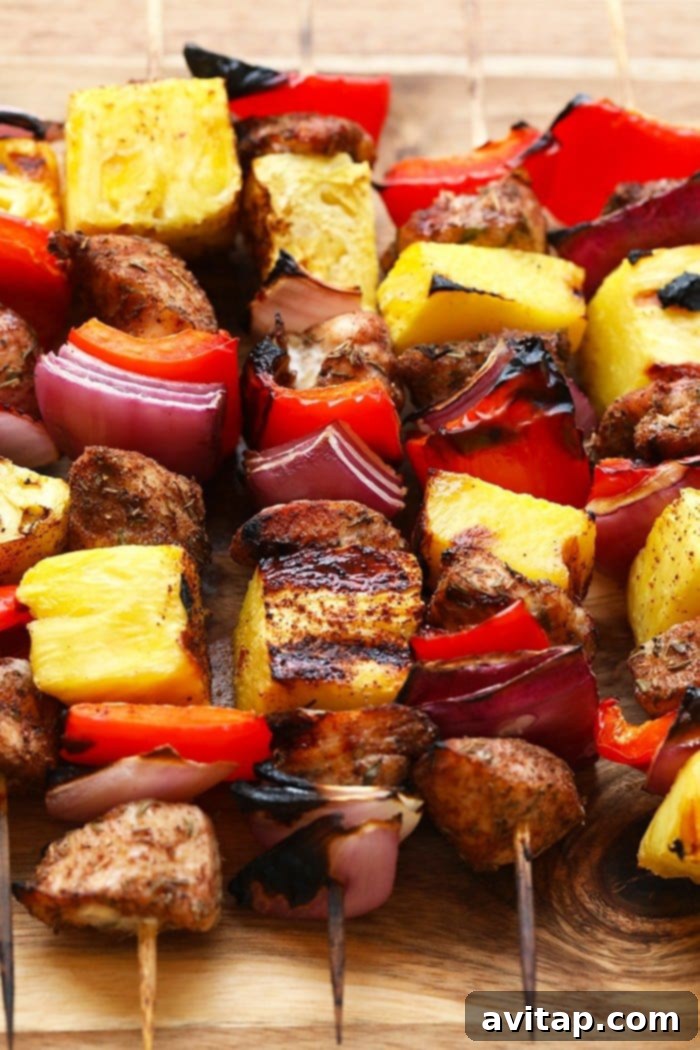 Cooked Jerk Chicken and Pineapple Kebabs on a metal tray