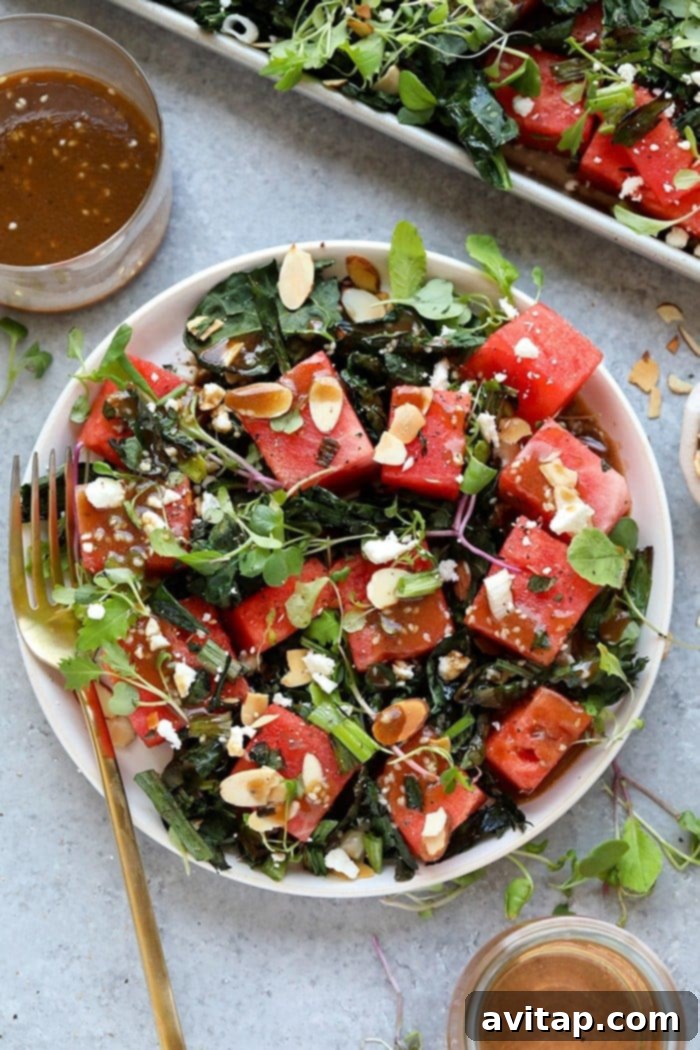 A vibrant plate of grilled watermelon and kale salad, showcasing its fresh ingredients and appealing colors.