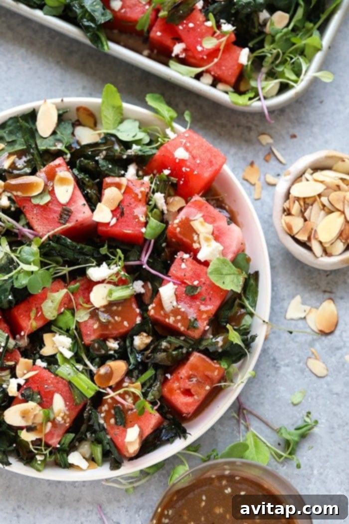 A large bowl filled with freshly prepared grilled kale and watermelon salad, ready to be served.