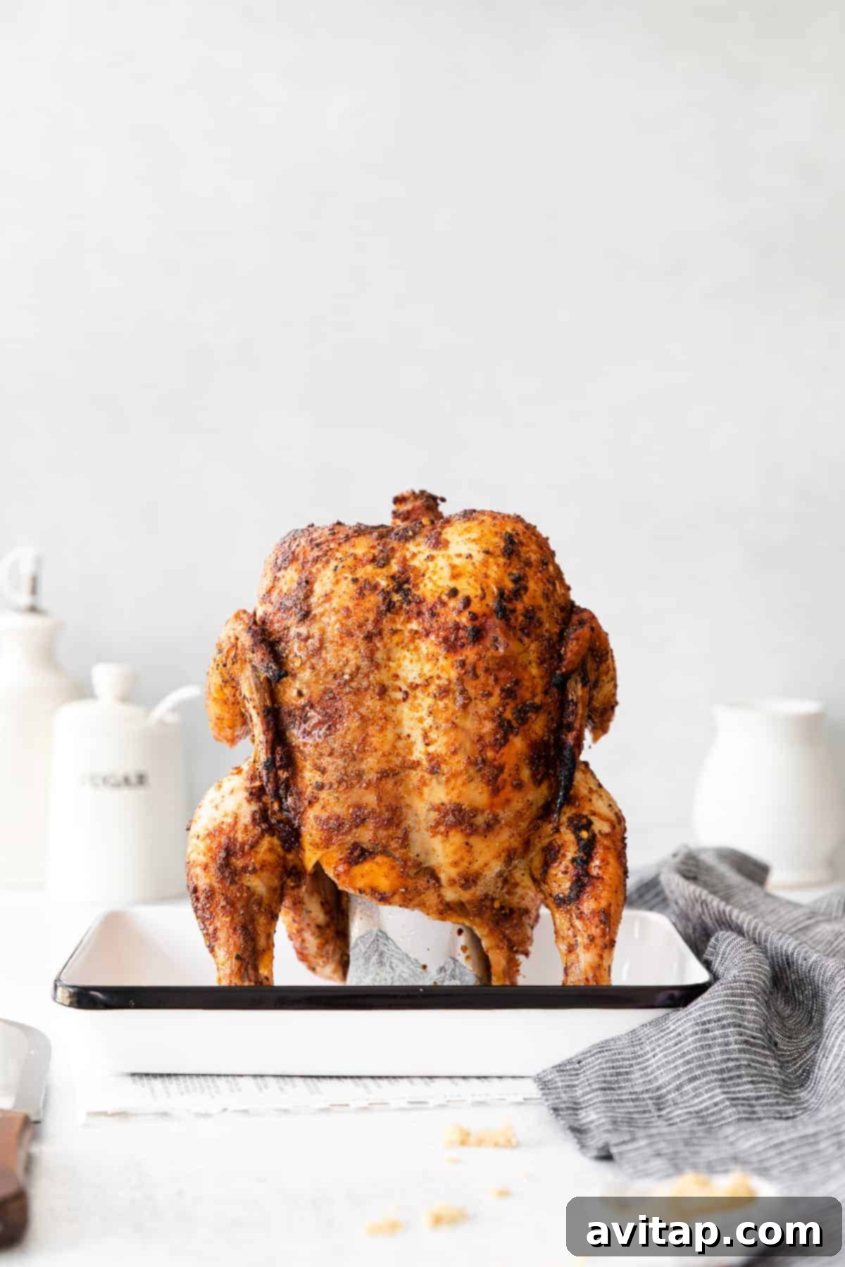 Oven-Roasted Beer Can Chicken: Crispy Skin, Juicy Meat Beer can chicken roasted in a roasting pan in the oven, showcasing its golden-brown, crispy skin.