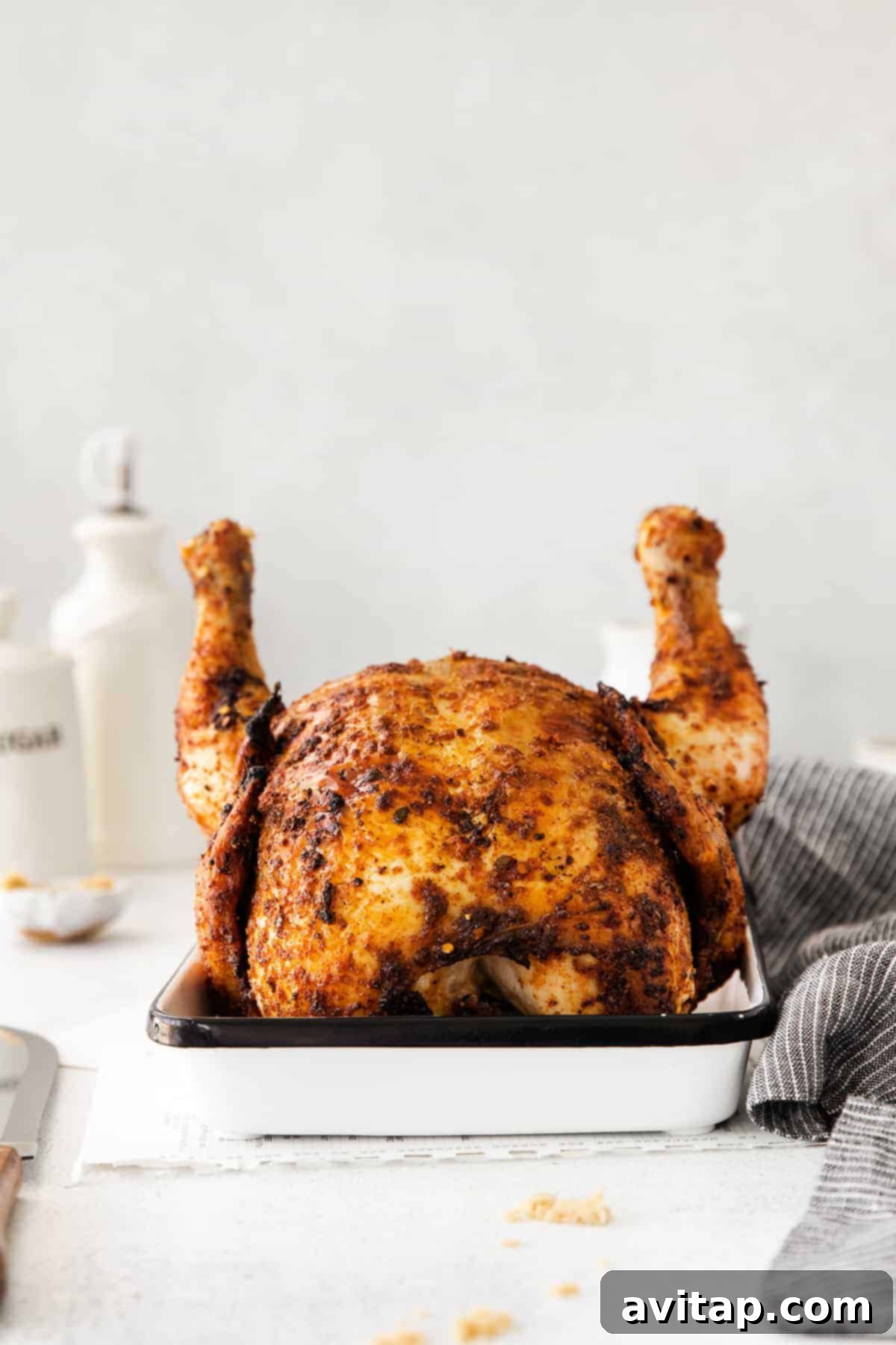 Whole Roasted Chicken Resting in Pan A whole roasted chicken, in a pan, resting after cooking, ready to be carved and served.