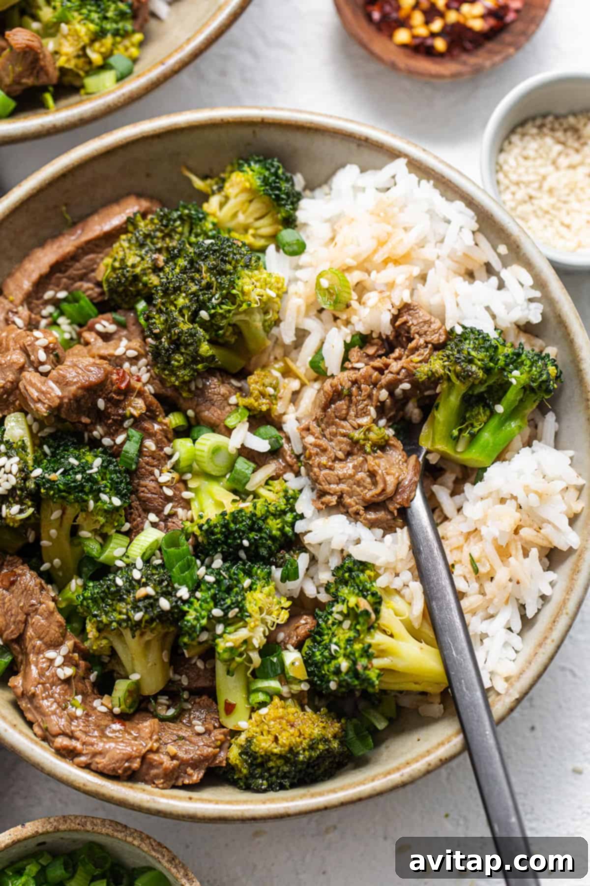 A vibrant bowl of Instant Pot Beef and Broccoli, showcasing tender beef, bright green broccoli, and a glistening, savory sauce, ready to be enjoyed.