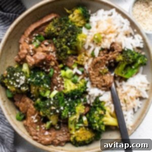 A beautifully presented bowl of Instant Pot Beef and Broccoli, garnished with sesame seeds and ready to serve.