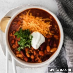 A bowl of classic Instant Pot Chili with savory ground beef, showcasing a rich, thick texture with beans and tomatoes.