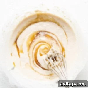 Cobbler topping batter in a mixing bowl, showcasing its smooth, pourable texture.