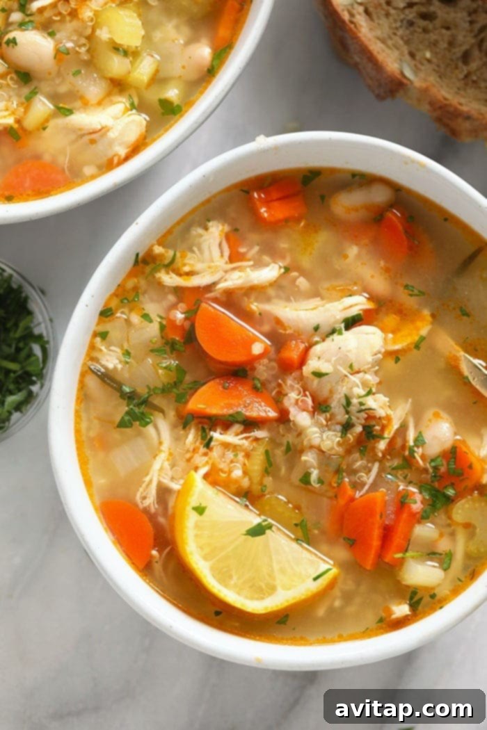The healthy chicken soup that will make you feel better in an instant. Meet our amazing Chicken Quinoa Soup that's naturally gluten-free, protein-packed, and flavor-filled. chicken quinoa soup in a bowl