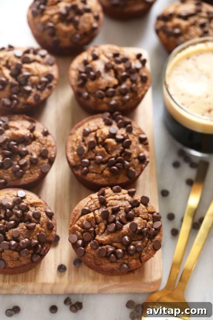 Easy 4-Ingredient Gluten-Free Pumpkin Muffins Delicious gluten-free pumpkin muffins arranged on a rustic cutting board, ready to be enjoyed as a perfect fall treat.