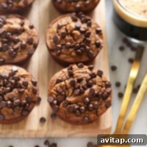 Delicious gluten-free chocolate chip muffins on a wooden cutting board, a perfect fall treat.